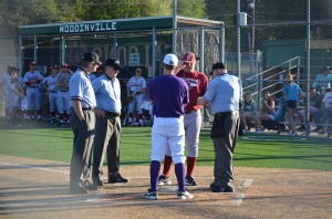 Coaches meeting at home plate for Kingco Quarterfinal playoff game